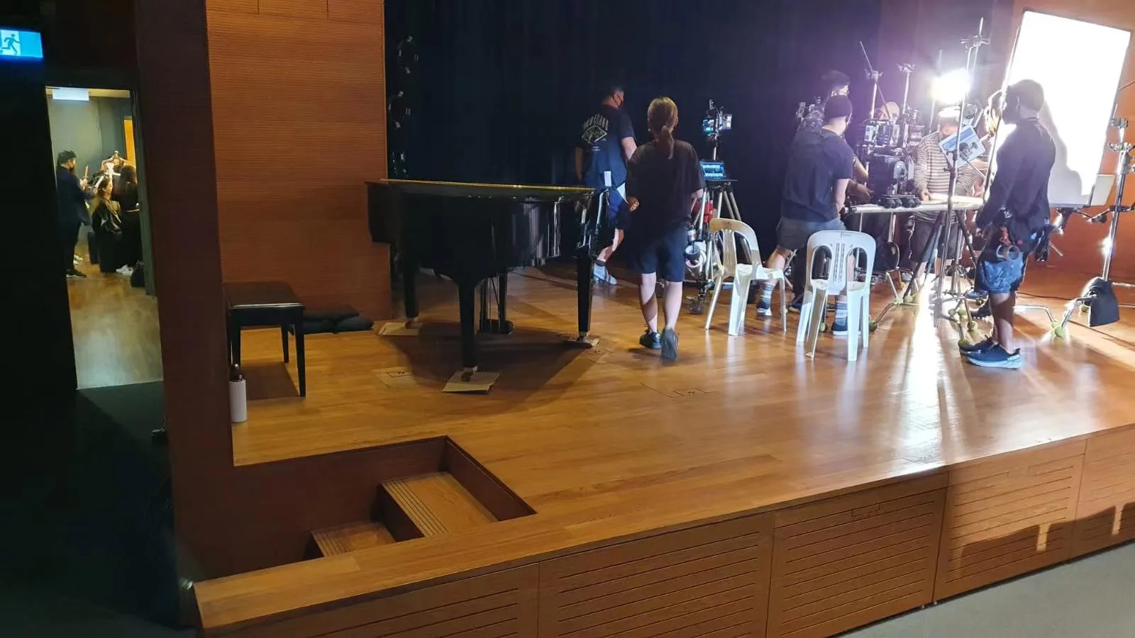 A grand piano set up on a hall stage