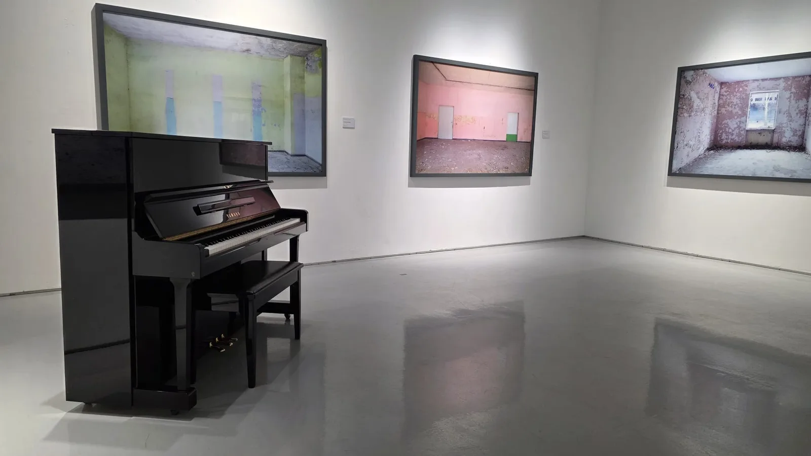 An upright piano in an exhibition at The Columns Gallery