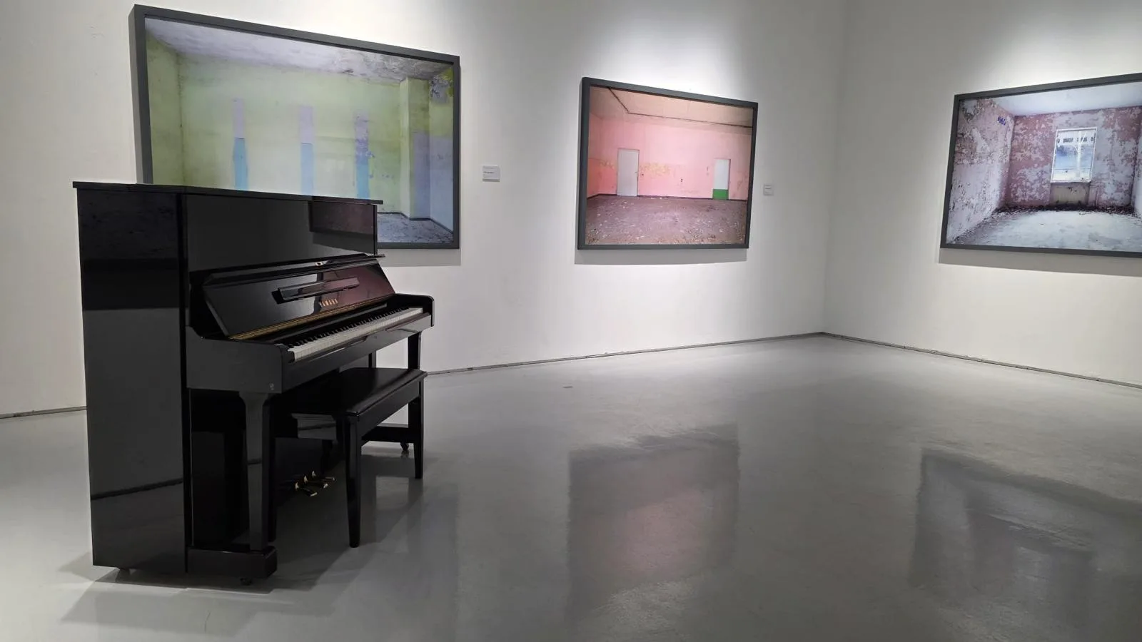 An upright piano in an exhibition at The Columns Gallery