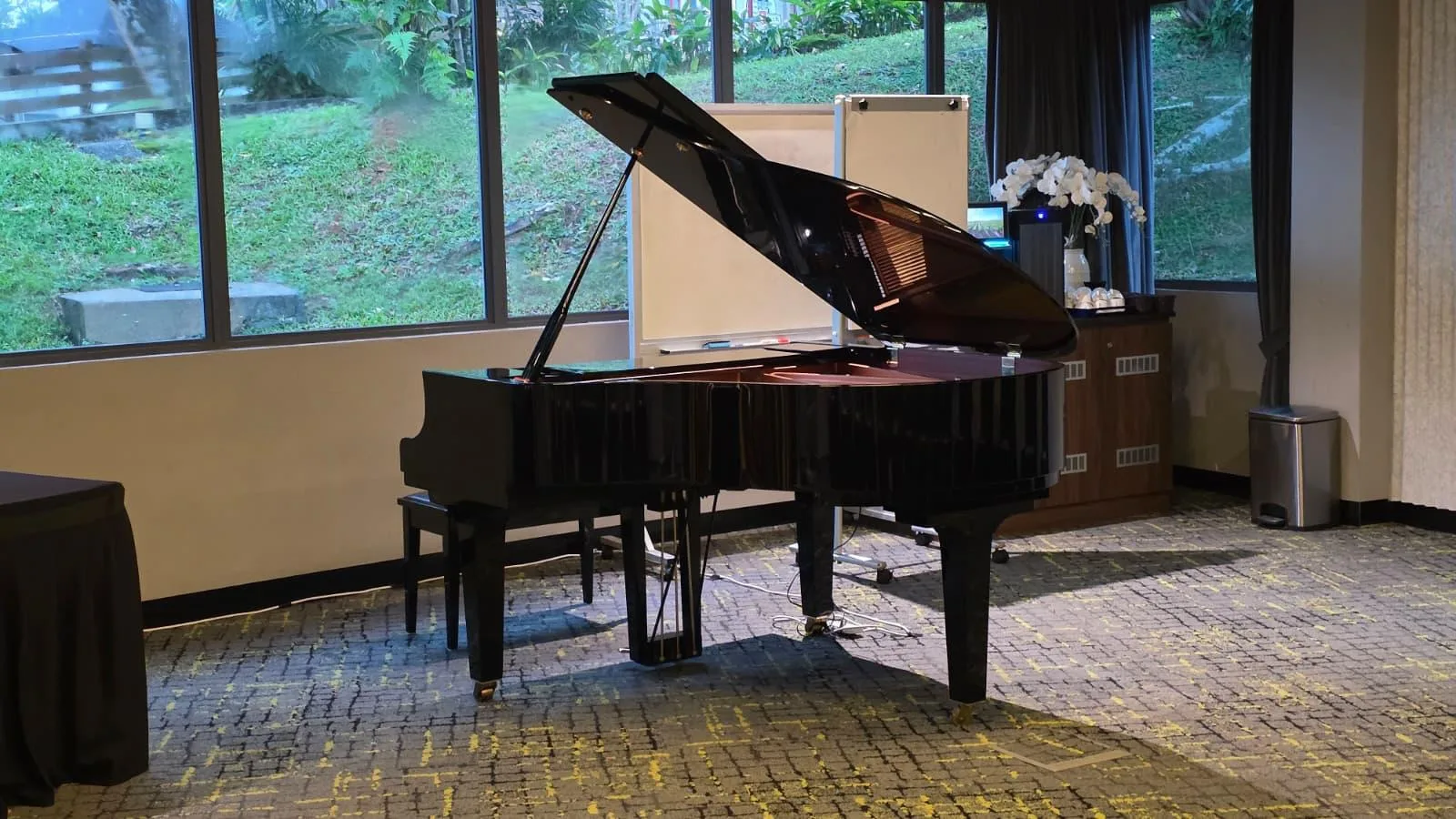 A grand piano by the windows of a function room