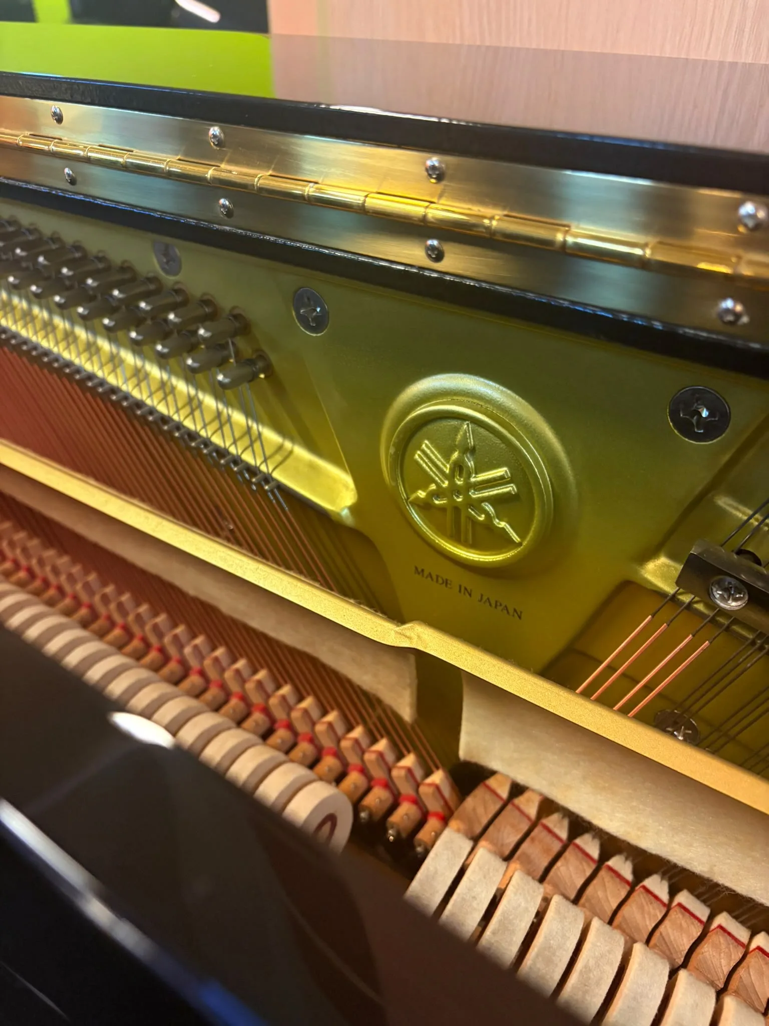 The action and plate of a Yamaha upright piano with the front panel off