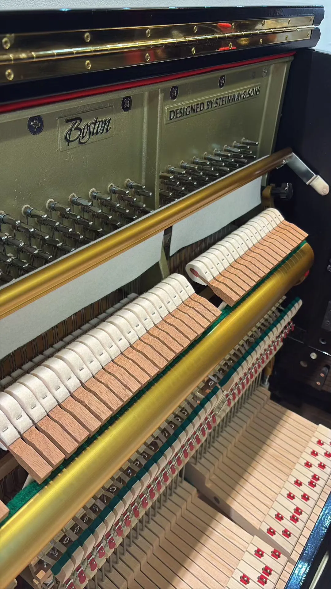 The plate and action of a Boston UP-132E upright piano