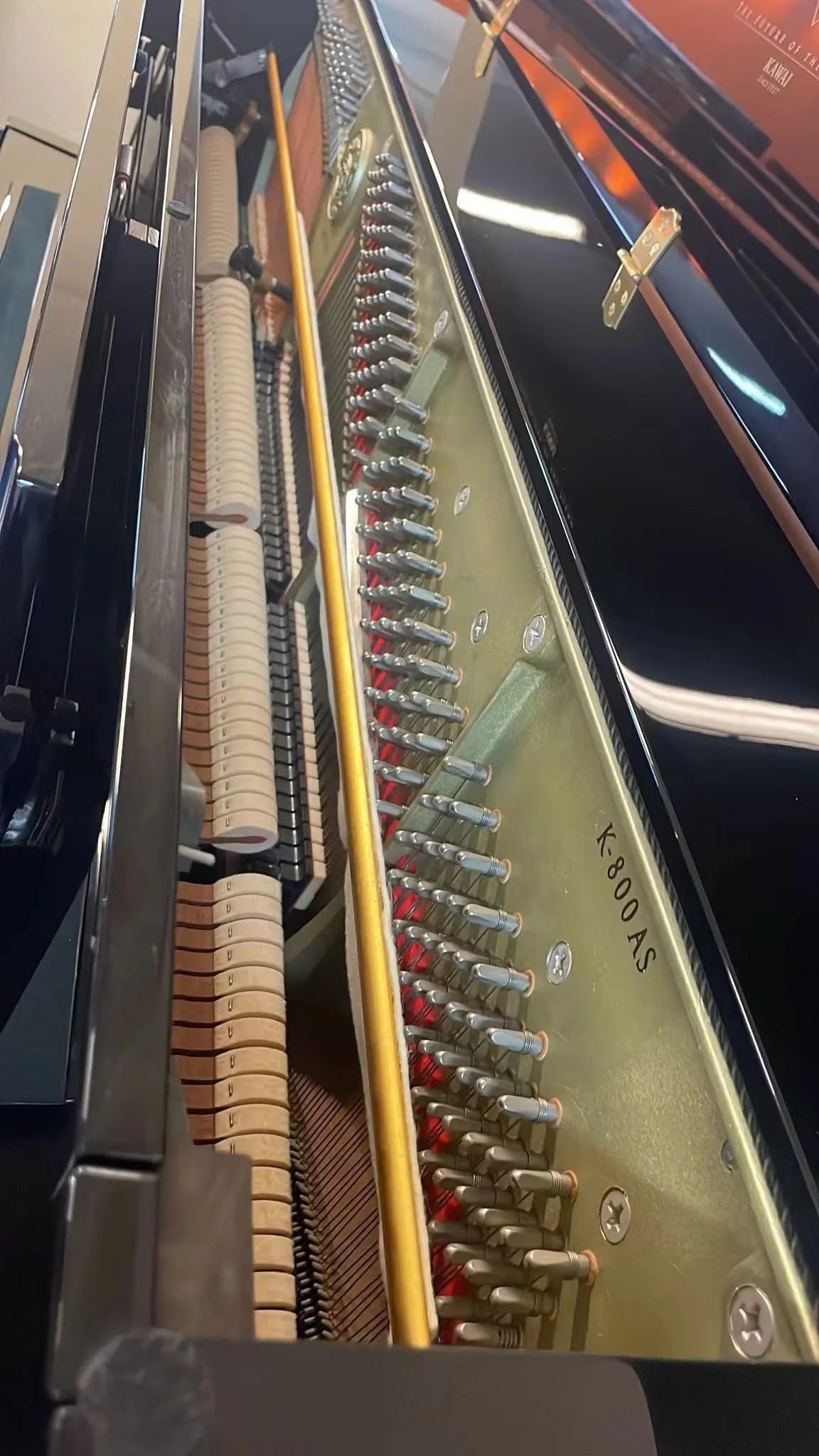 The model name K-800AS cast into the plate of a Kawai upright piano