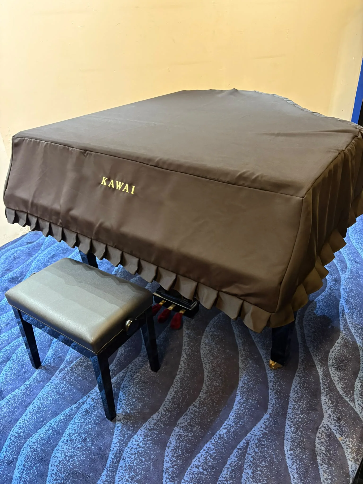A Kawai GX-1 grand piano under its fitted Kawai cover