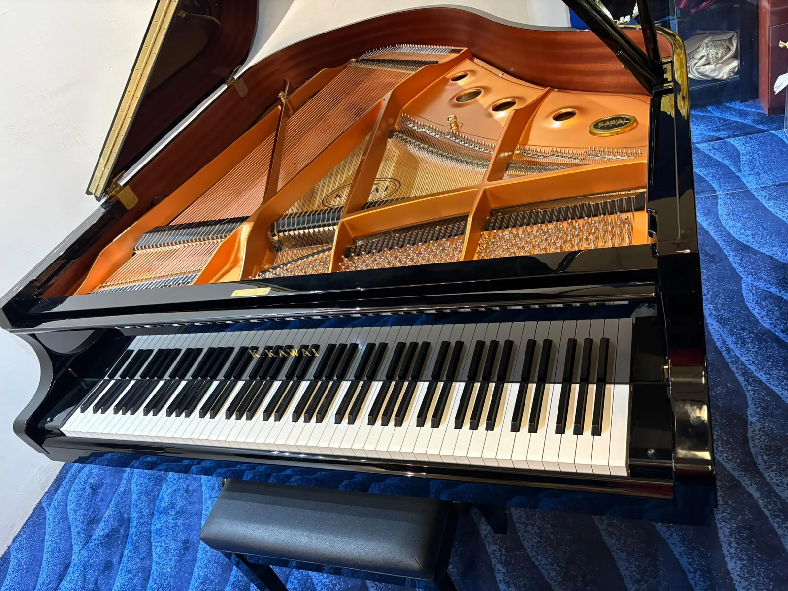 The keyboard of a Kawai GX-1 grand piano with the lid raised