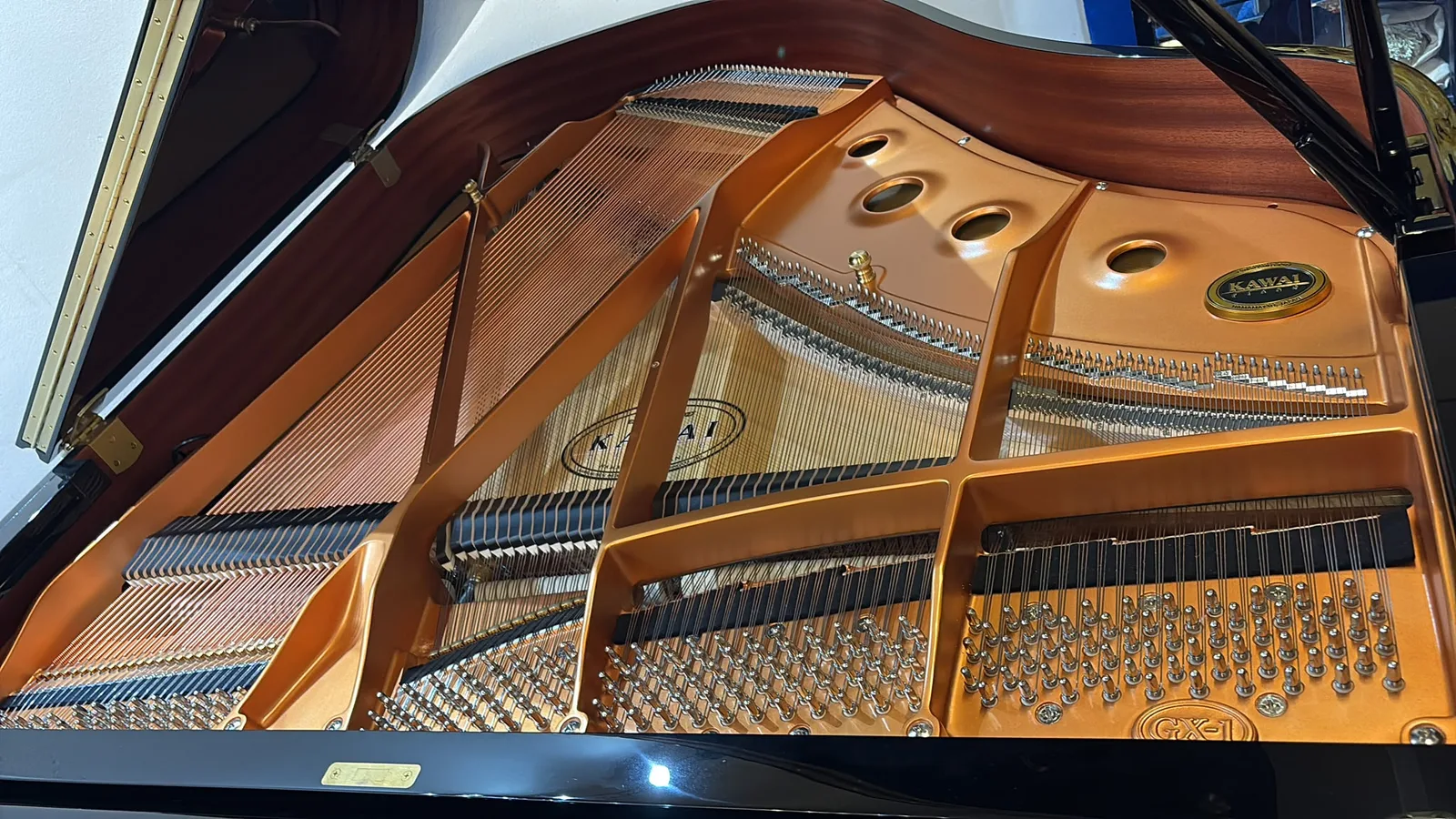 The plate, bracing and strings inside a Kawai GX-1 grand piano