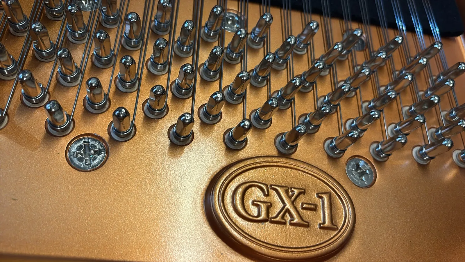 The model name GX-1 cast into the plate of a Kawai grand piano