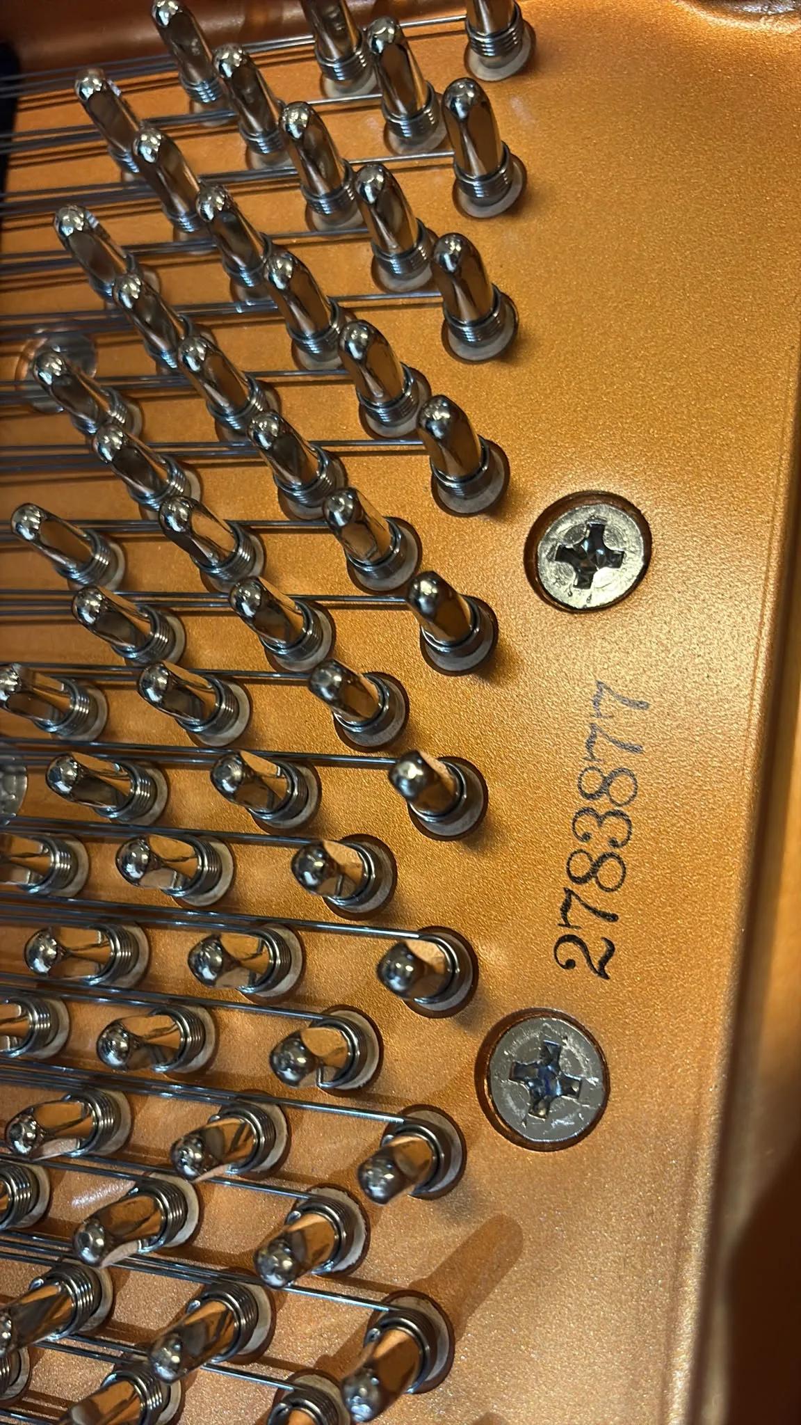 The serial number 2783877 stamped on the plate of a Kawai GX-1 grand piano
