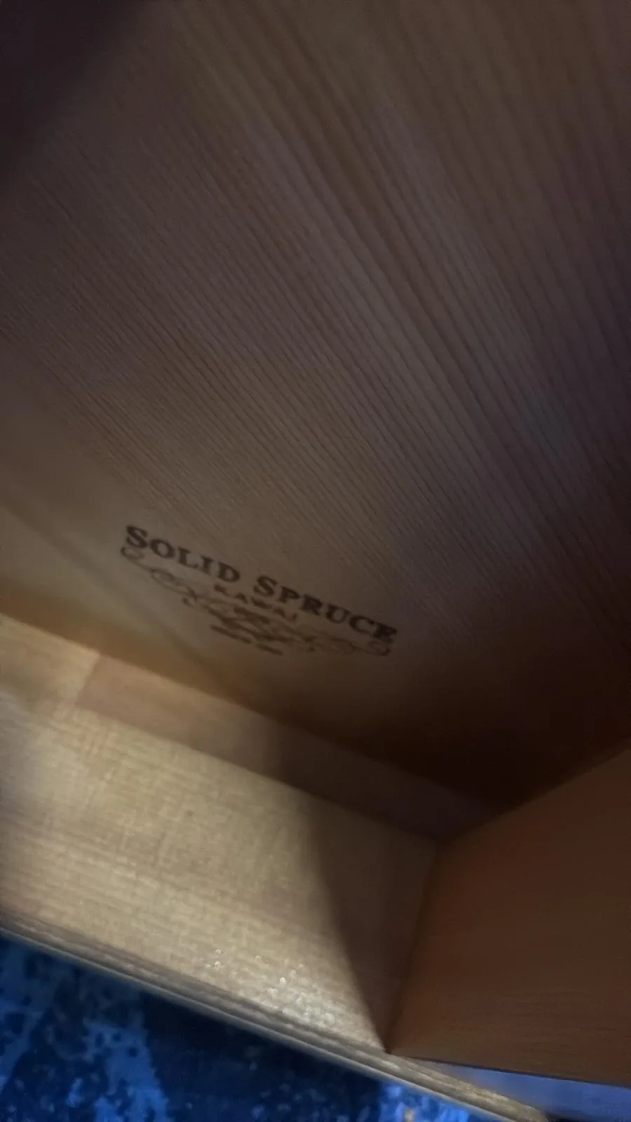 Solid spruce stamped on the soundboard inside a Kawai upright piano