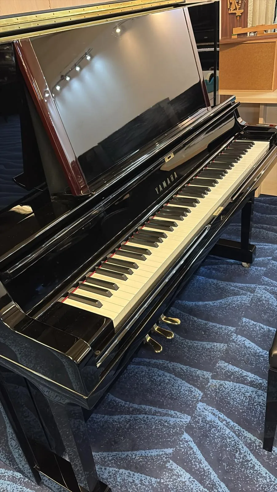 A Yamaha upright piano open on the floor at IMM
