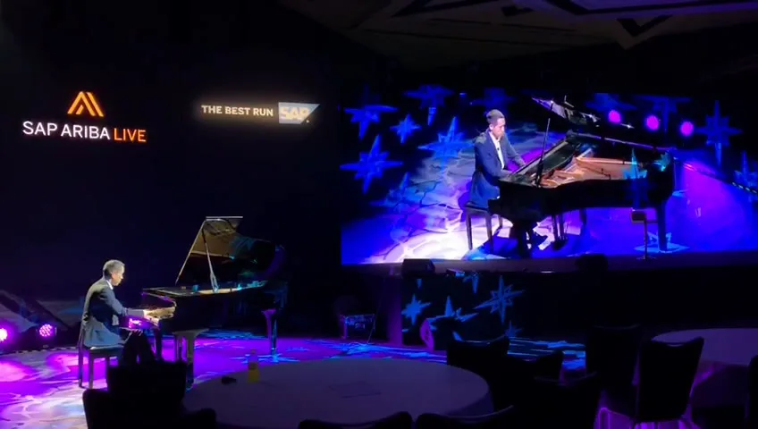Grand pianos on a concert stage under stage lighting
