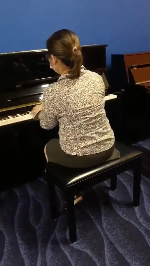 An upright piano being played