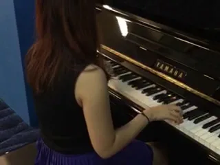 A Yamaha upright piano being played